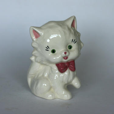 vintage ceramic cat with pink bow and green eyes 