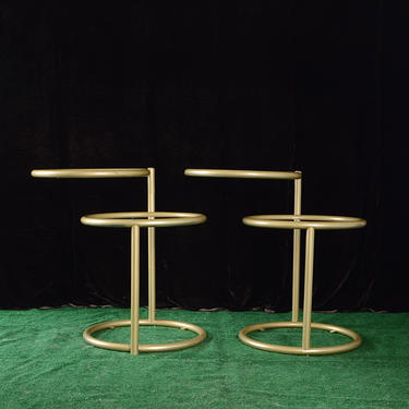 Pair of gold and glass 2 tier swivel top side tables 