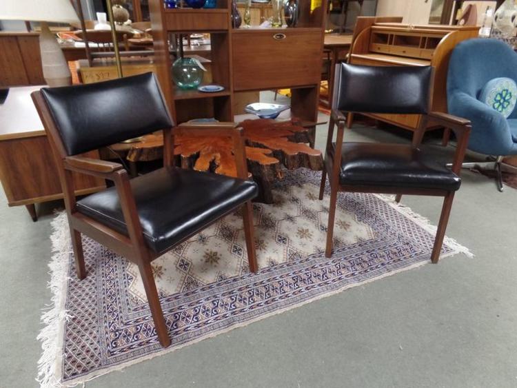 Pair of Mid-Century Modern walnut arm chairs with black vinyl upholstery