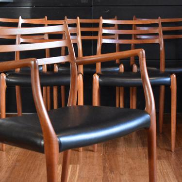 Six Danish teak Niels Moller 78/62 dining chairs w/black faux leather (five armless, one captains) 