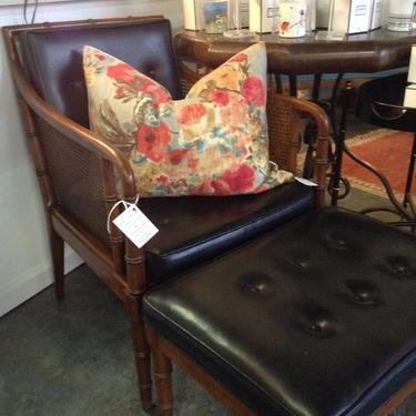 Vintage caned  chair and ottoman with black tufted leather
