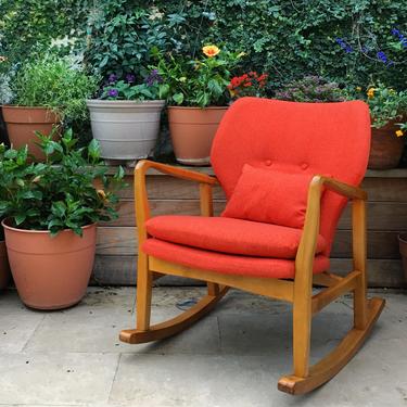 orange mid century modern style rocking chair with wooden frame