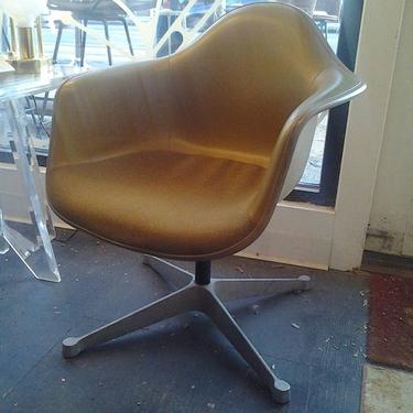 Herman Miller padded fiberglass shell swivel chair on star base.