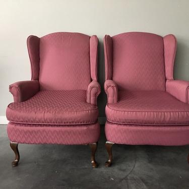 pair of vintage wingback chairs in rose pink.