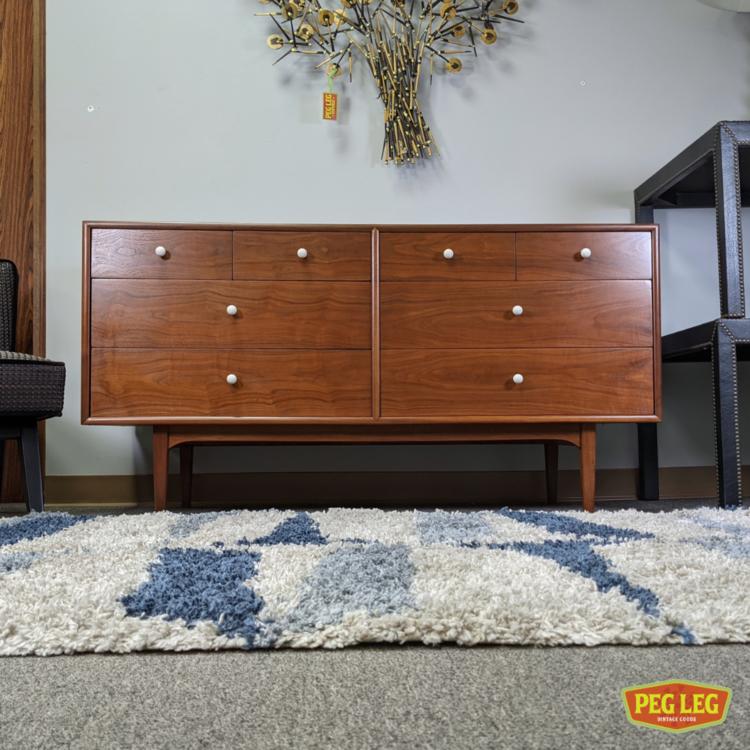 Mid-Century Modern walnut dresser with white porcelain pulls from the 'Declaration' collection