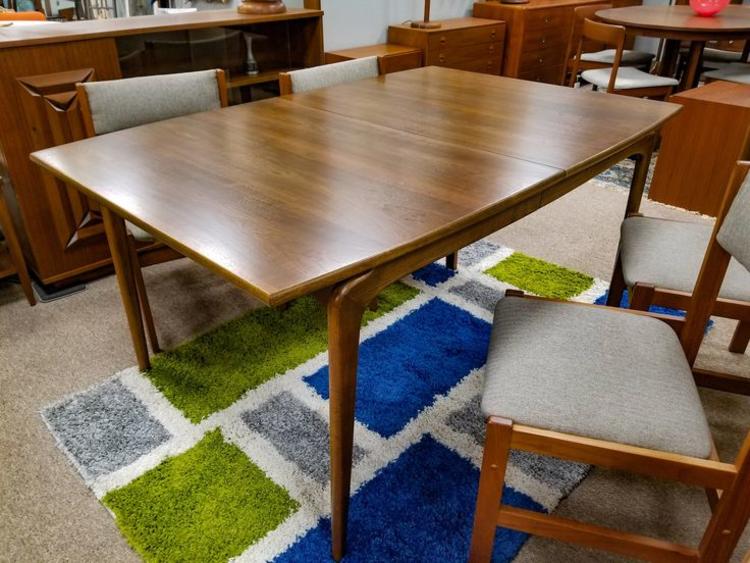                   Mid-Century Modern walnut dining table with 2 leaves from the Perception collection