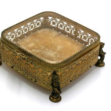 vintage filigree gold metal jewelry box with cherubs and glass lid 