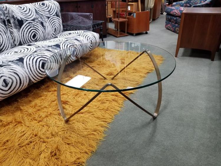                   Mid-Century Modern glass top coffee table with brass ribbon base