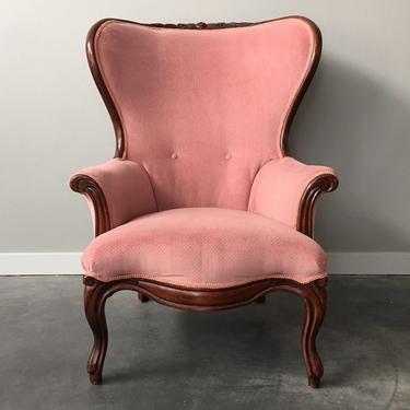 vintage curved wingback chair in pink.