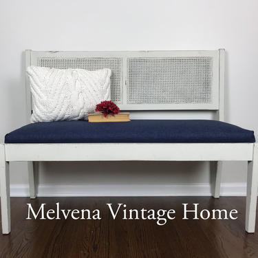 Vintage rattan bench with navy upholstered cushion 