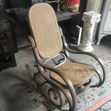 Adorable wooden rocking chair with cane webbing
