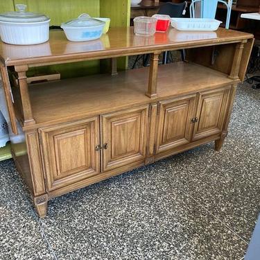Mid century server. Has two wings, four doors and two drawers! With leafs down 54.5” expands to 73.5” long, 19” deep, 31” tall