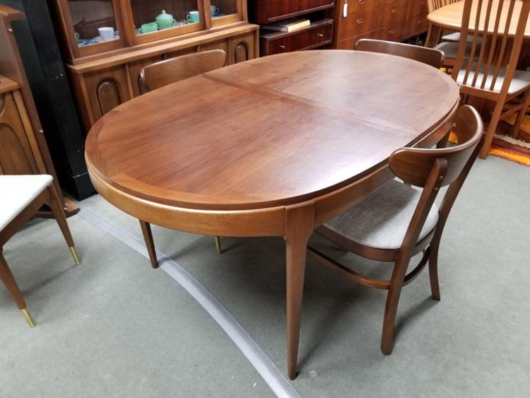 Mid-Century Modern oval walnut dining table with two 18" leaves