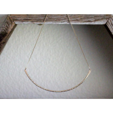 Contour Collar Necklace, a perfect everyday piece of jewelry full of effortless yet enviable style. This necklace features a thick long bar, curved expertly in the natural shape of the neck to be the most compatible piece of adornment.