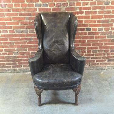 Slender old world leather arm chair with pretty legs