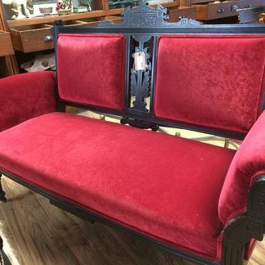 Eastlake sofa with red velvet upholstery. $600