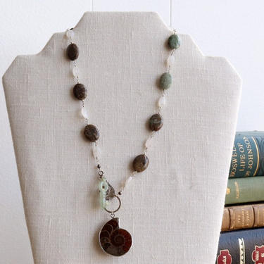 Woman Inherits the Earth [assemblage necklace: fossil ammonite, jade, jasper, moonstone, sterling silver] 