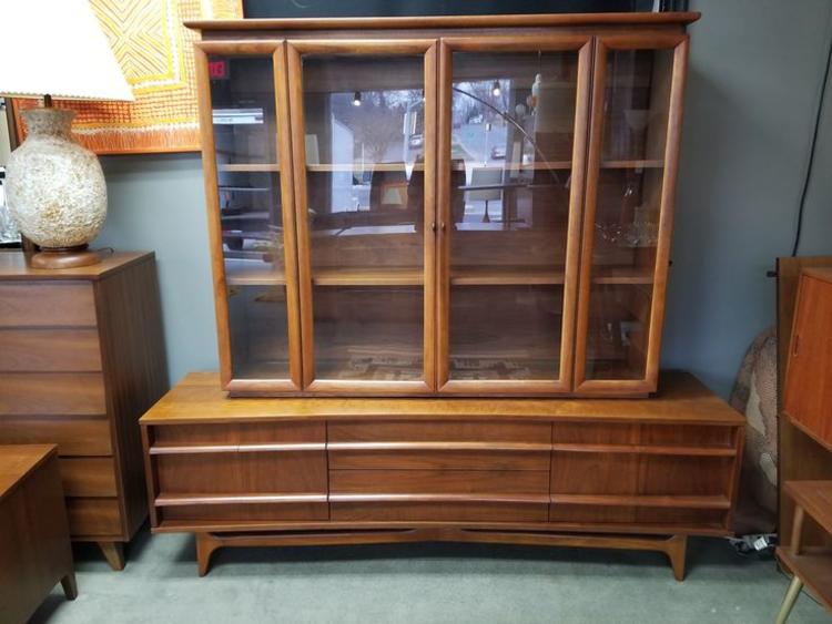                   Mid-Century Modern walnut wall cabinet with curved front