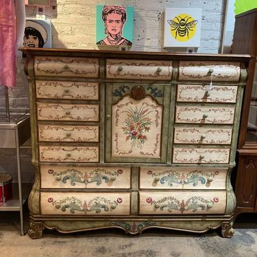 Baroque style painted cabinet. 15 drawers of velvet lined storage. 3 shelves behind the door. 66” x 22” x 55”