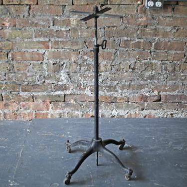 vintage industrial height-adjustable cast iron base rolling clothes or display rack 