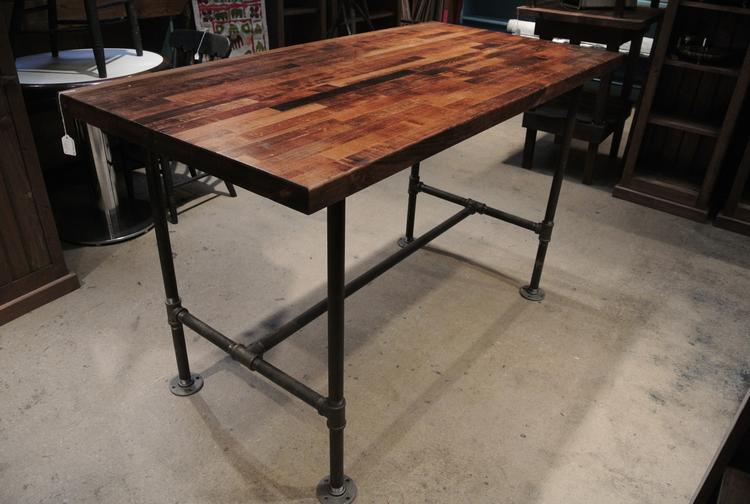 Industrial table with pipe fitting body and butcher block wood top