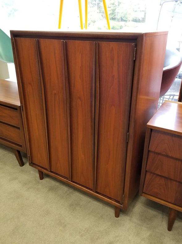                   Mid-Century Modern walnut armoire with sculpted front