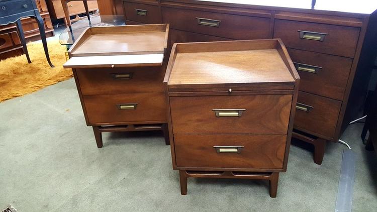 Pair of mid-century nightstands with pull-out laminate shelf and brass pulls