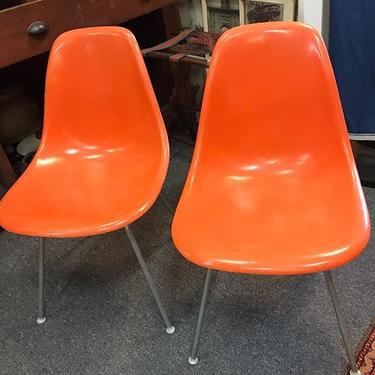Orange Herman Miller molded plastic side chairs. $150 each