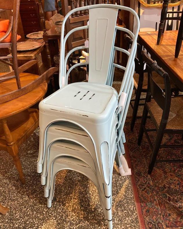 Stack of powder blue metal chairs 4 available