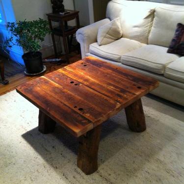 Heart pine rustic coffee table with hand hewn legs 