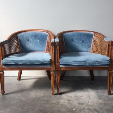 pair of vintage cane barrel chairs in blue.