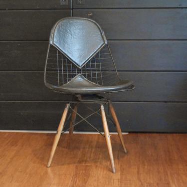 Eames PKW-2 wire 'bikini' chair - black leather on dowel swivel base, circa 1960s 