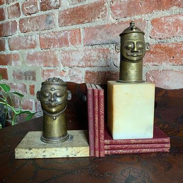 Antique brass heads on marble