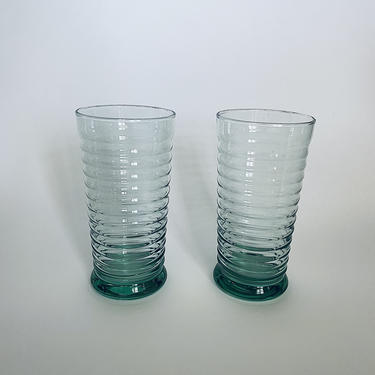 A Set of Tall Green Ribbed Glasses 