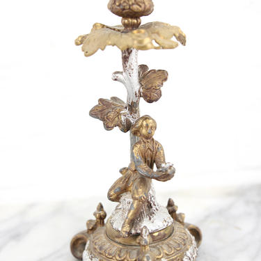 Ornate Brass Candlestick with Figural Man Holding a Bird's Nest 