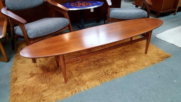 Mid-Century Modern walnut surfboard coffee table by Heritage. Peg Leg Vintage.