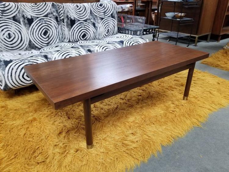                   Mid-Century Modern walnut coffee table with brass accents