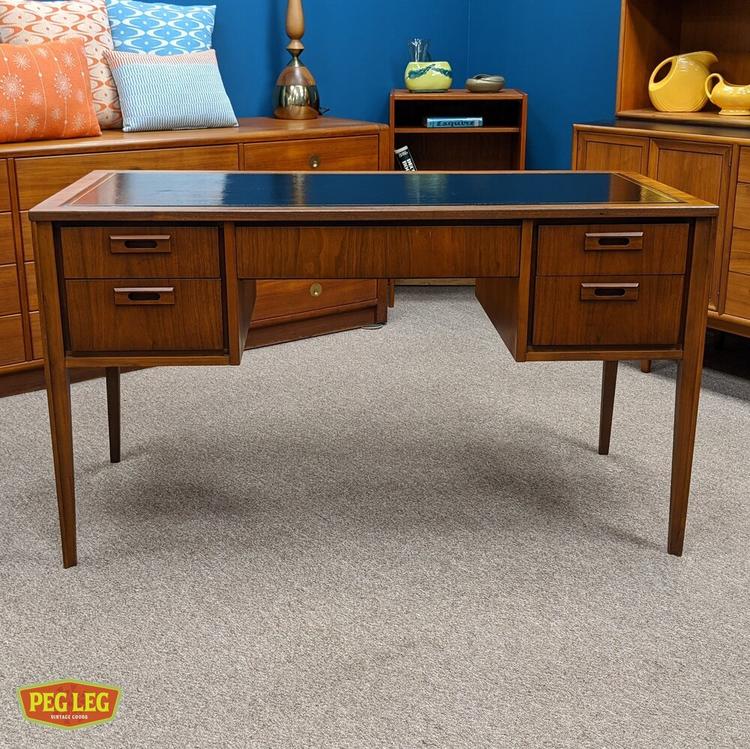 Mid-Century Modern walnut desk with inset finger pulls and finished back