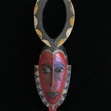 Vintage Red Painted Wood West African Ivory Coast Guro Mask Elongated Face with Large Round Horns and Tribal Markings 