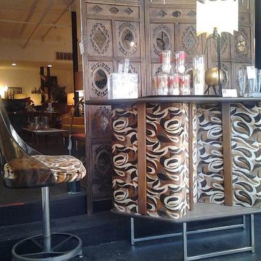 Mod upholstered bar with matching swivel stool. "Swinger" era bar is padded in velvety faux leopard with formica top, lots of storage for bottles and barware on rear and footrest