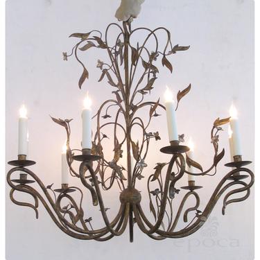 a fanciful and large-scale french 1940's gilt iron 8-light chandelier with floral and foliate vines