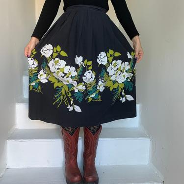 1950's piqué cotton black pleated full skirt with white roses and green fern border print.  26 inch waist vintage 