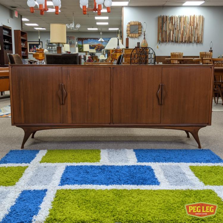 Mid-Century Modern walnut credenza with sculpted legs and pulls
