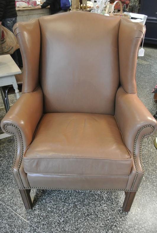 Brown leather wingback chair. $350