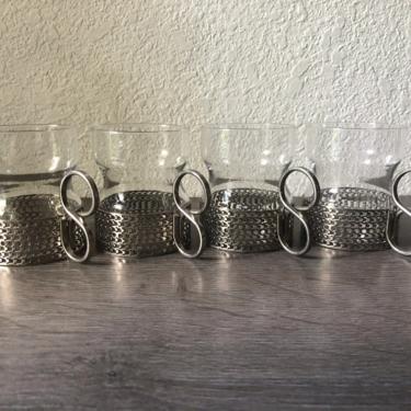 Vintage set of four Iittala Timo Sarpaneva tea glasses,  vintage Scandinavia. Holder in silver colored metal 