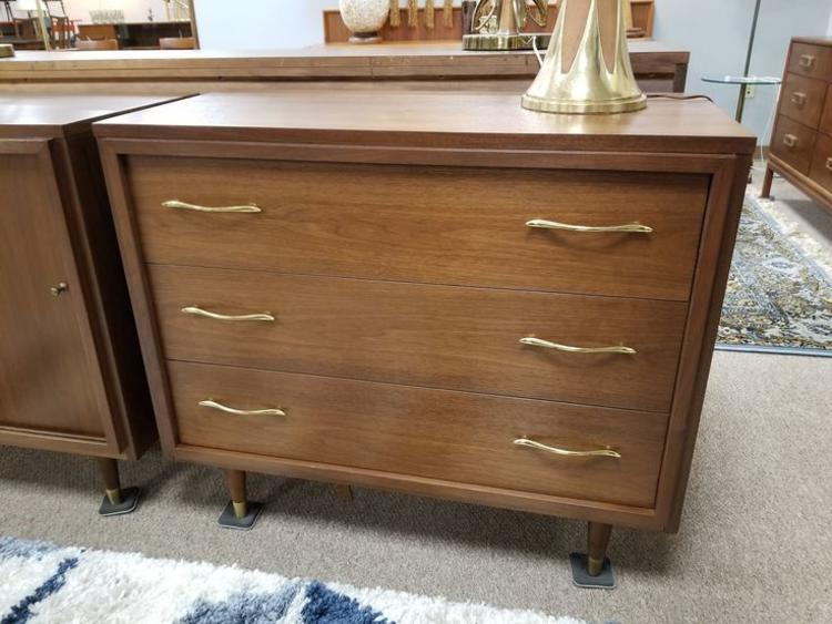                   Mid-Century Modern walnut three drawer dresser with brass pulls
