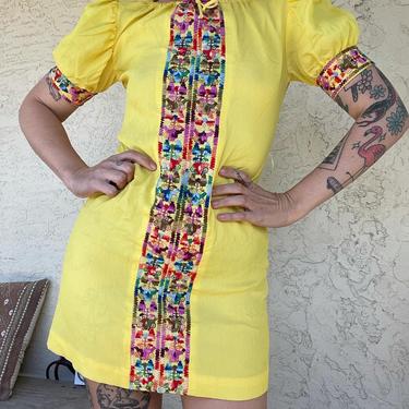 Adorable 1970s lemon yellow mini dress with rainbow embroidery details 