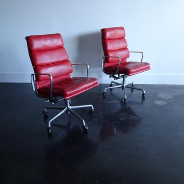 Pair Eames Soft pad red leather executive chairs 