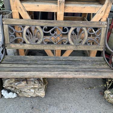 Wood bench with decorative wrought iron
