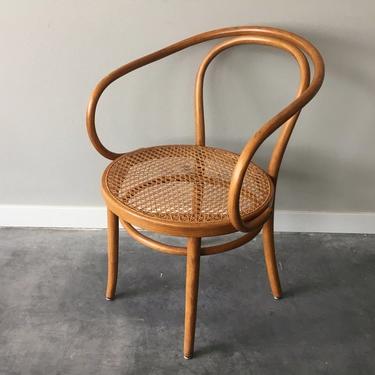 vintage mid century modern bent wood arm chair with cane seat.